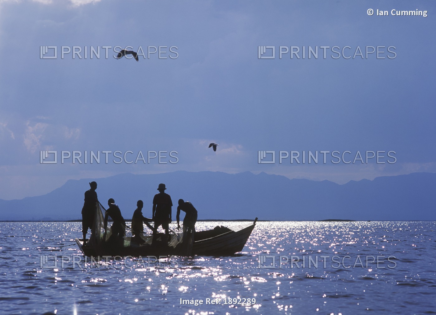 Fishermen Pulling Fishing Nets On Small Boat On Lake Chilwa