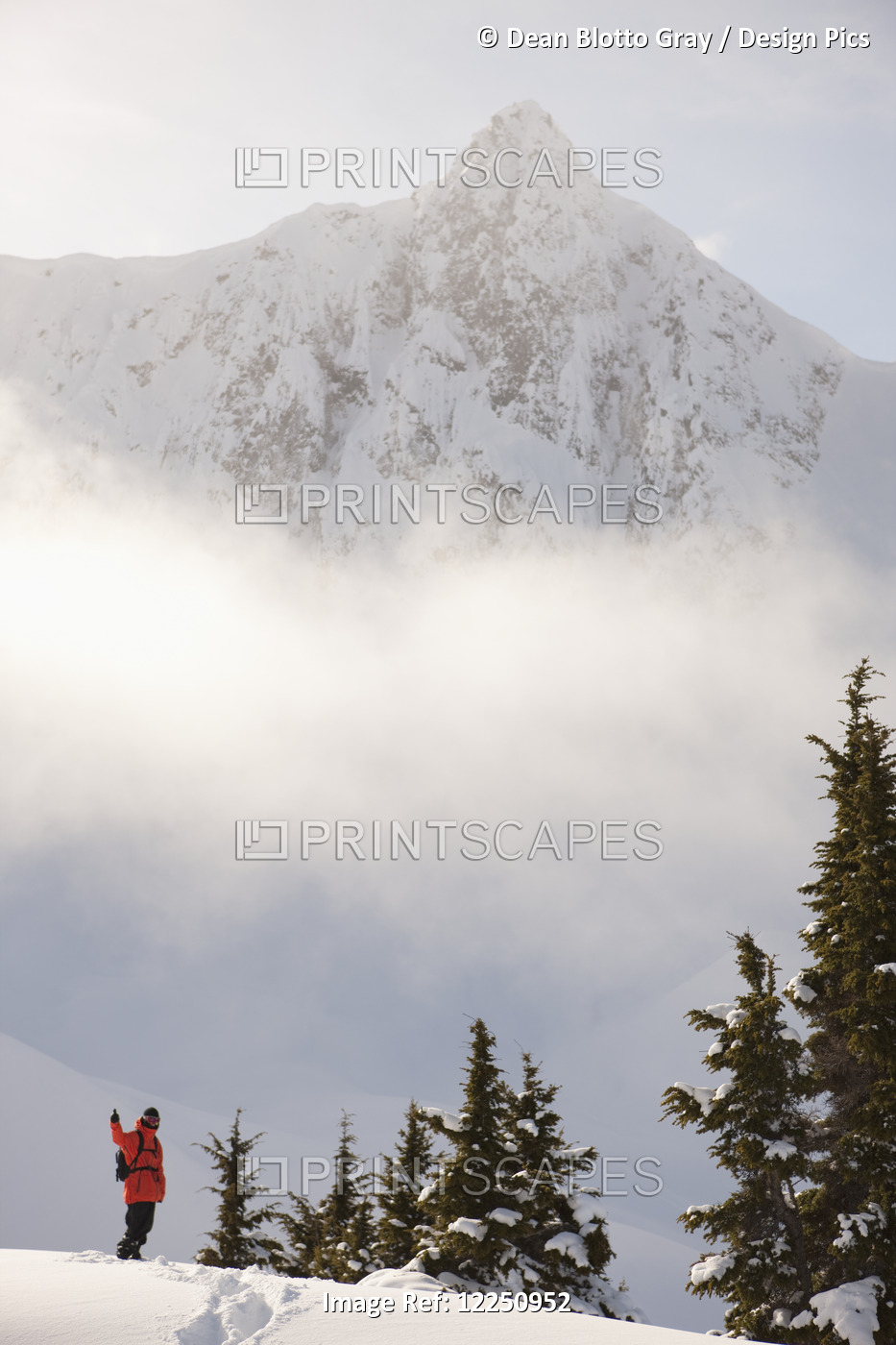 Snowboarder On A Ridge With Scenic Mountains And Fog In The Background, Haines, ...