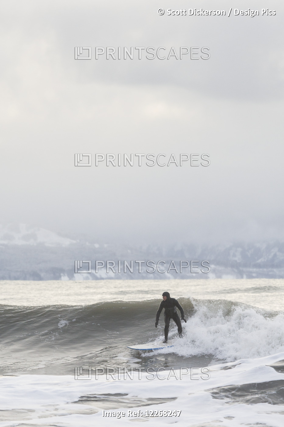 Person Surfing In Winter In Homer, Kenai Peninsula, Kachemak Bay, Alaska.
