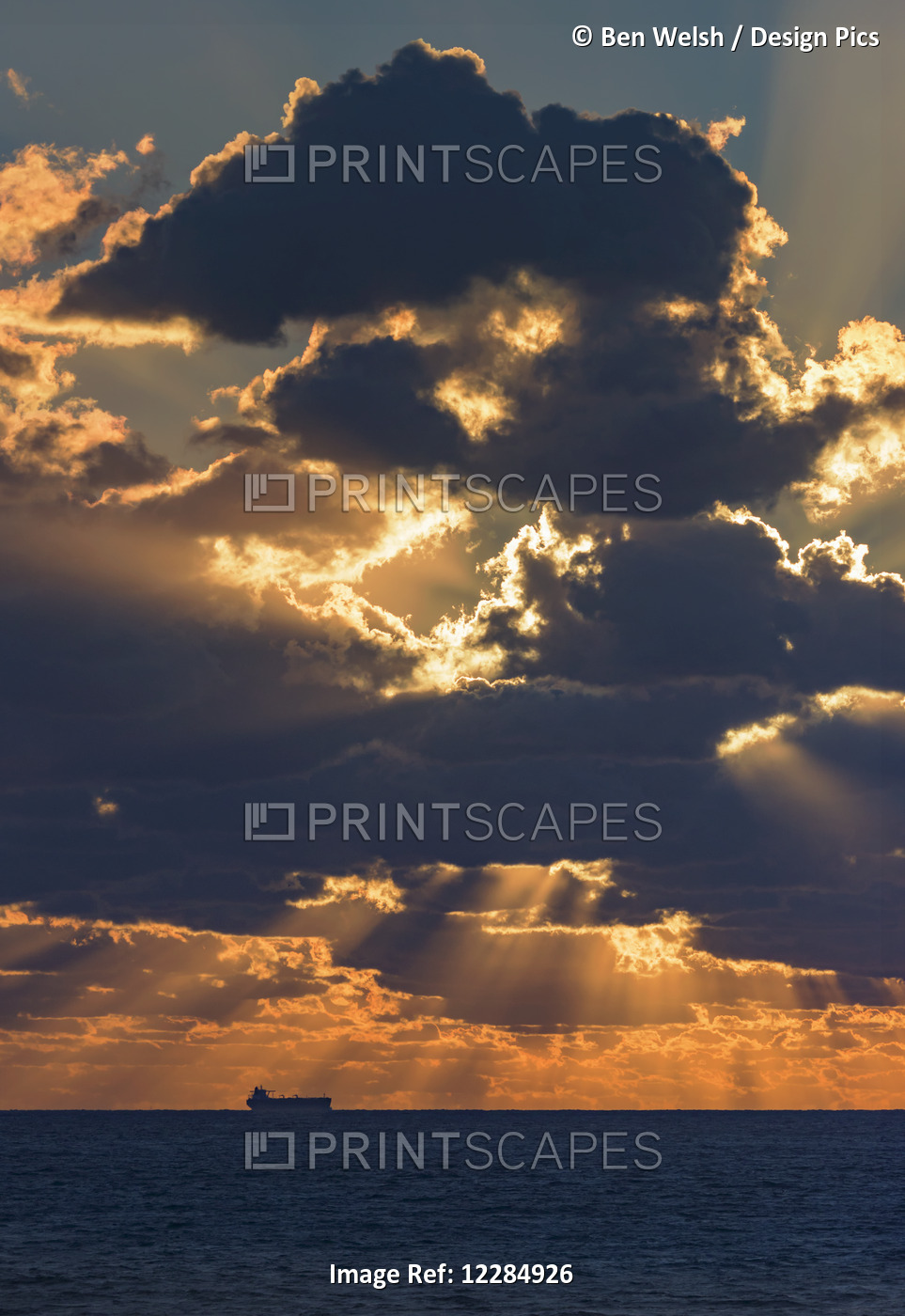 Dramatic Sky With Clouds Glowing At Sunset Over The Ocean And A Ship In The ...