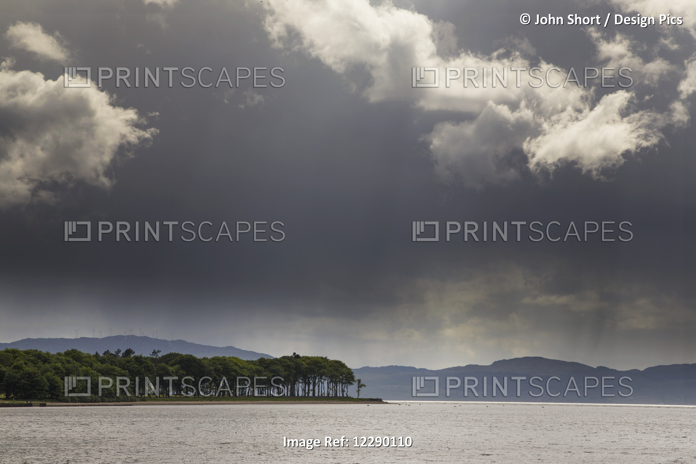 Trees And Mountains Along The Coastline Under Storm Clouds; Otter Ferry, ...