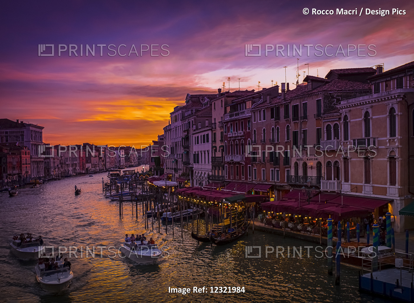A Dramatic And Colourful Sunset Over The Canal And Buildings, With Water Taxis ...