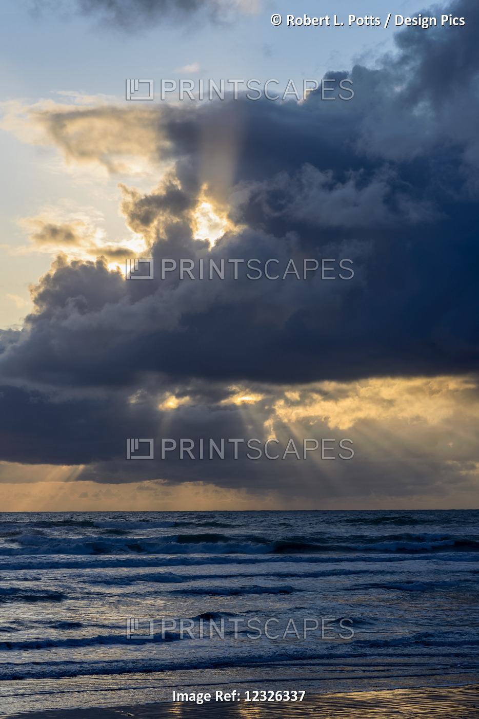 Sunbeams Flow Through Holes In The Clouds Along The Oregon Coast; Cannon Beach, ...