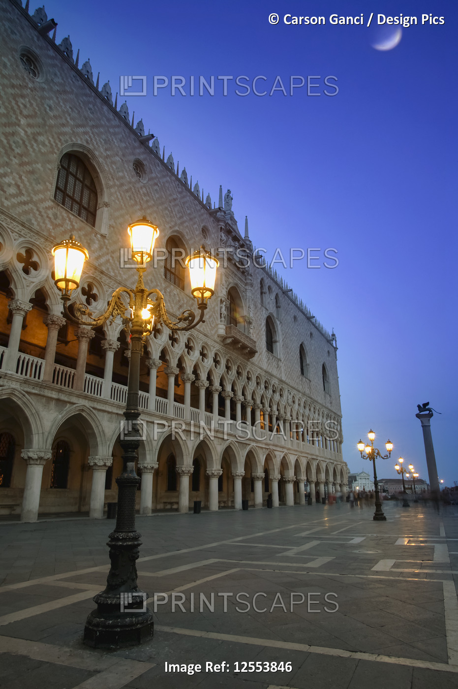Doge's Palace at dusk with illuminated lamp posts and a moon in the blue sky; ...