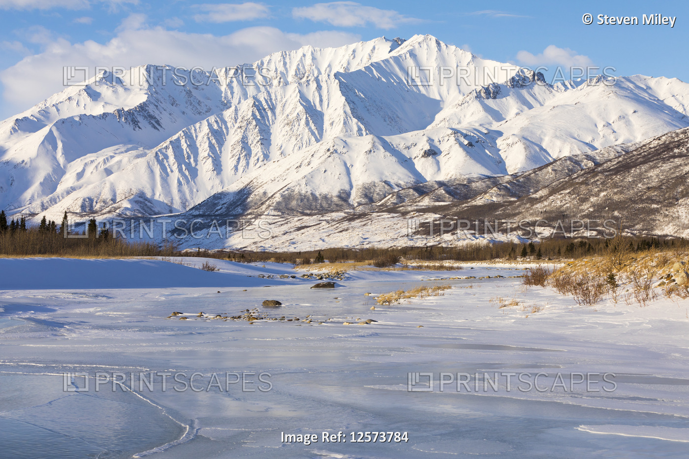 Mountains rise over the frozen Black Rapids Glacier drainage in the Alaska ...