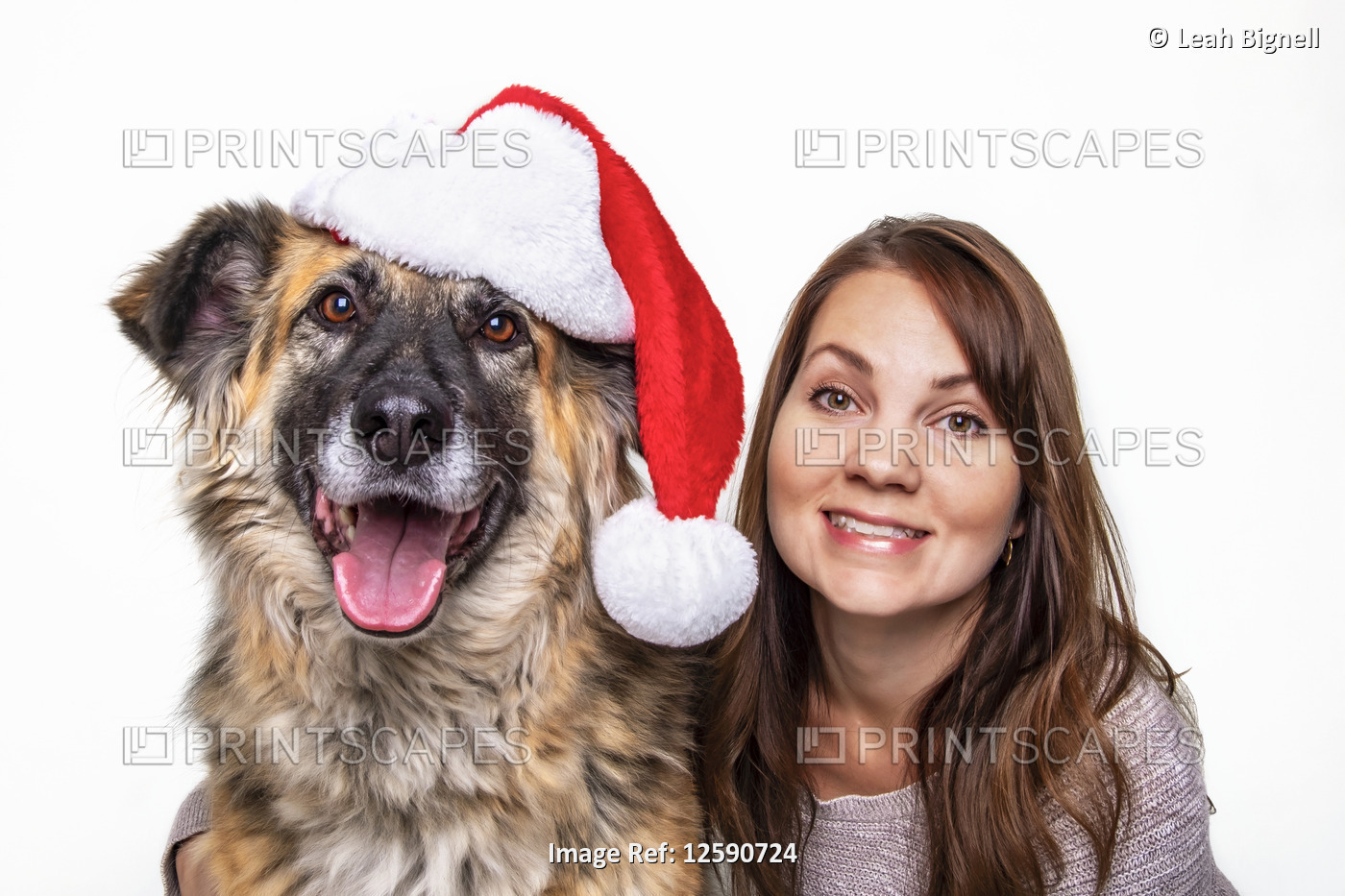 A Christmas portrait of a woman and her dog on a white background; Studio