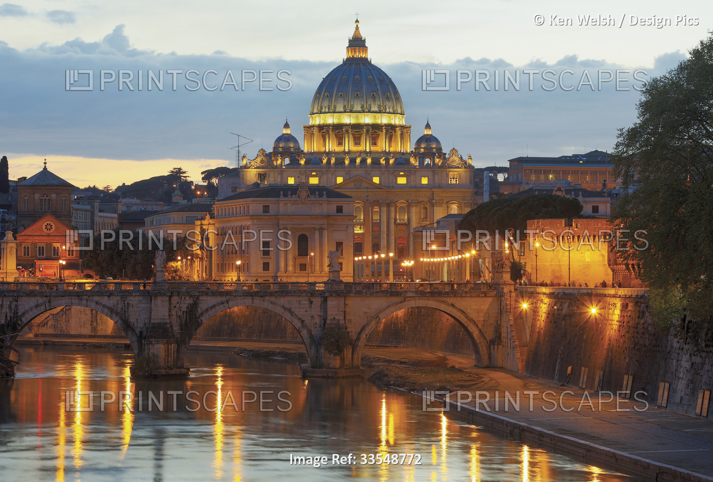 Rome, Italy.  Sant'Angelo bridge and St Peter's Basilica at dusk.  The historic ...