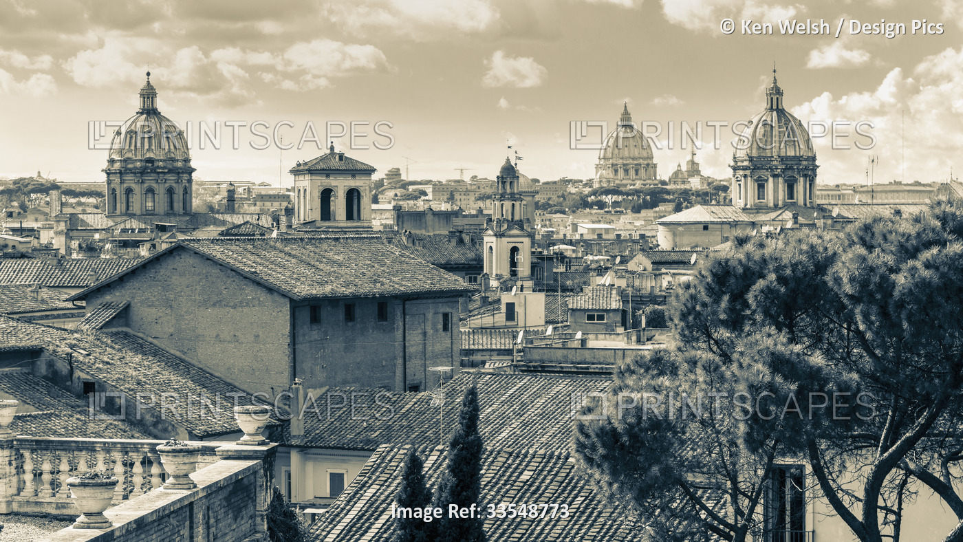 Rome, Italy.  Rooftops and domes. In the far distance is St. Peter's.  The ...