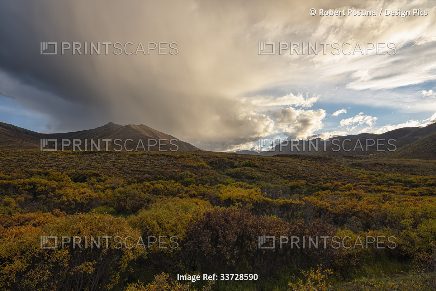 A passing shower hovers over Mount Boyle along the Dempster Highway. Fall ...