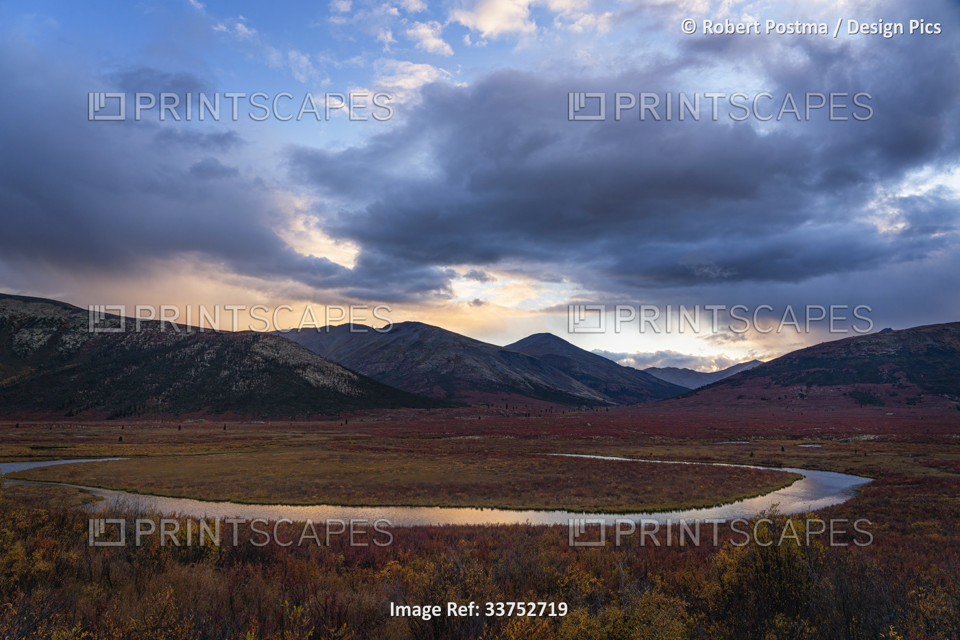 Beautiful sunset skies over a gentle flowing river in the wilds of the Yukon; ...