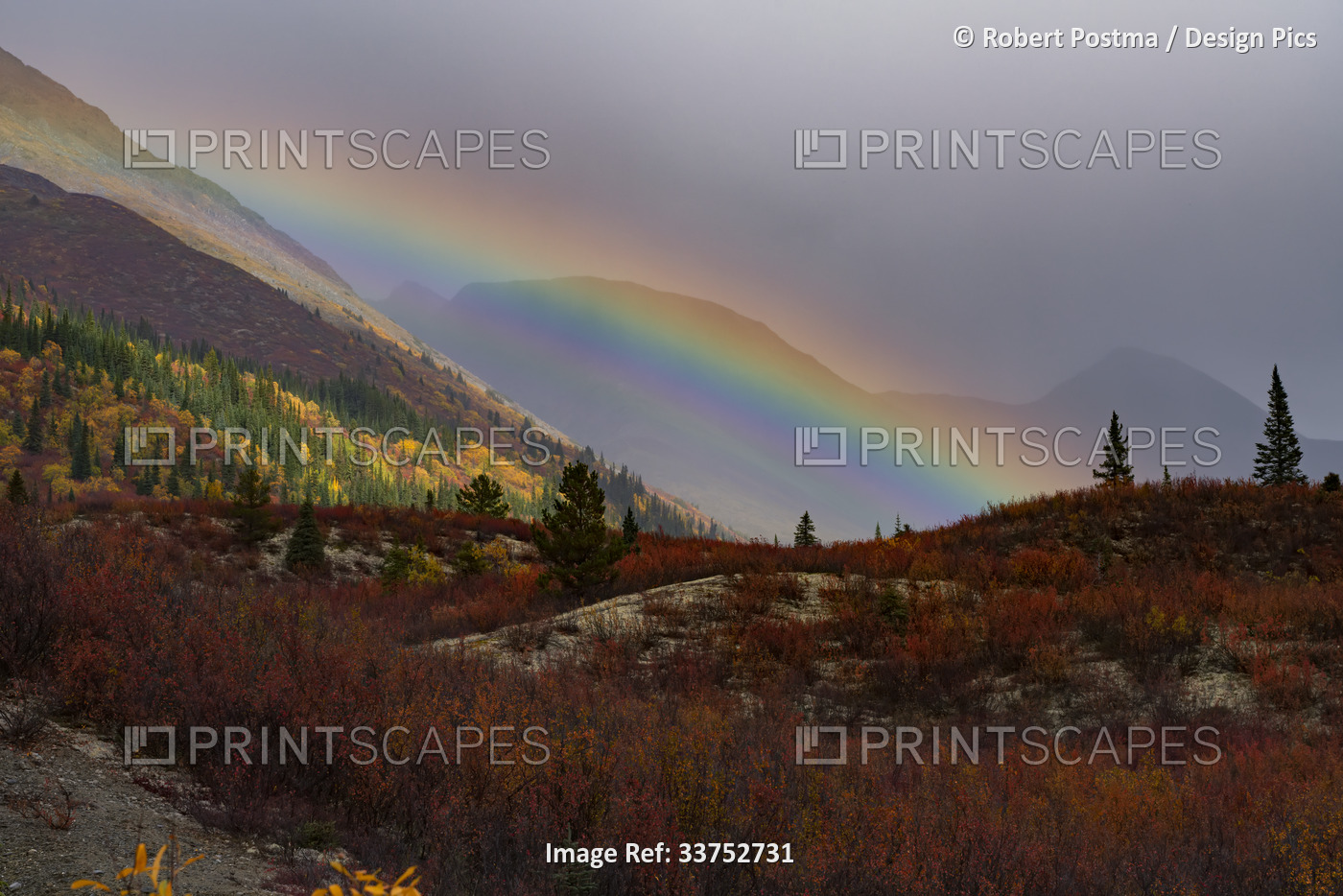 Rainbow across the vast mountainous landscape off of the Nahanni Range Road in ...